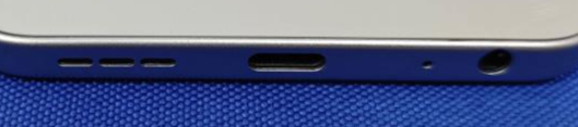 Bottom edge of the Tecno Spark 40 (KM5), the USB-C port with the primary microphone pinhole beside it